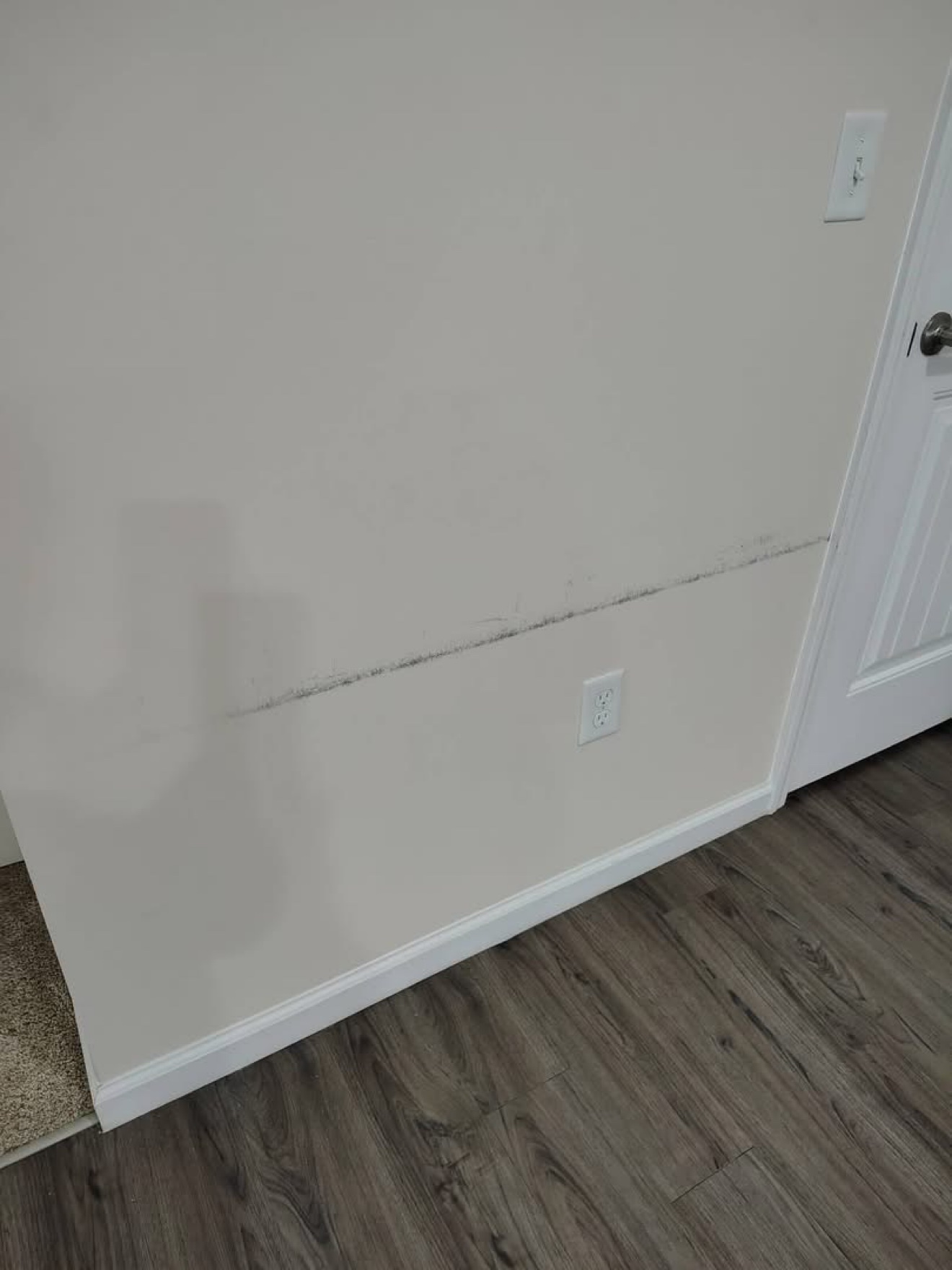 Scuff marks on a wall before treatment