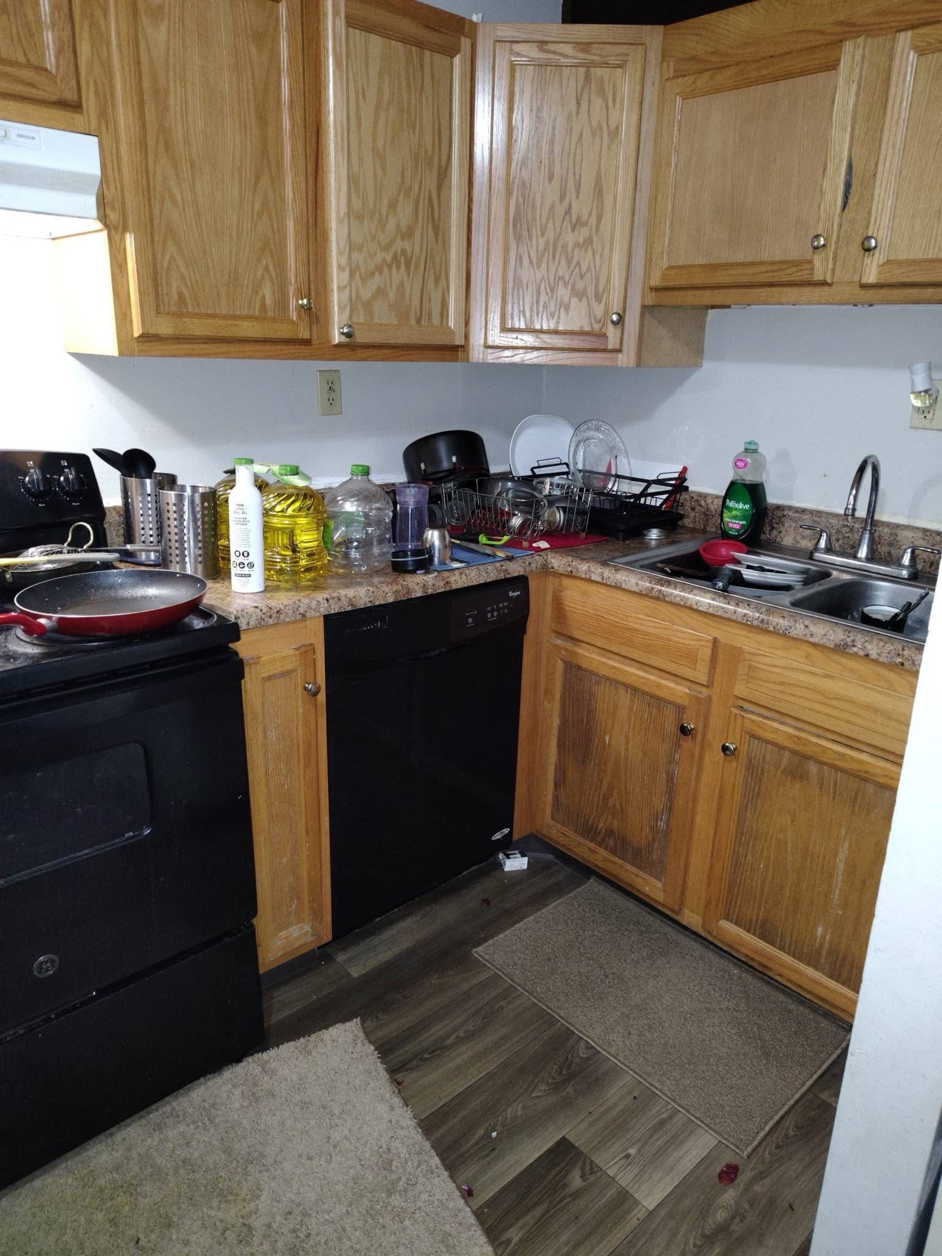 Crowded kitchen work area before cleaning
