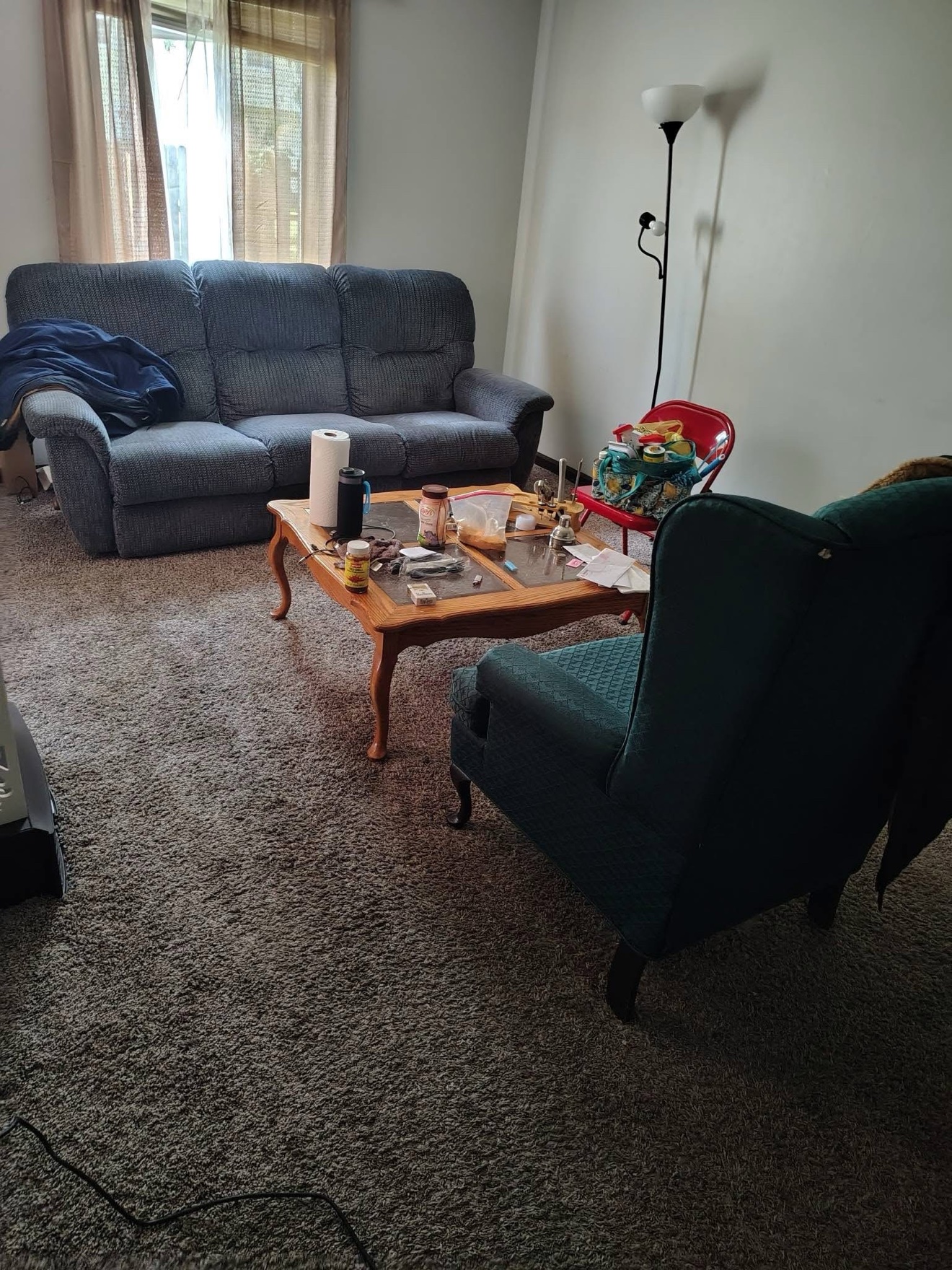 Cluttered living room before cleaning